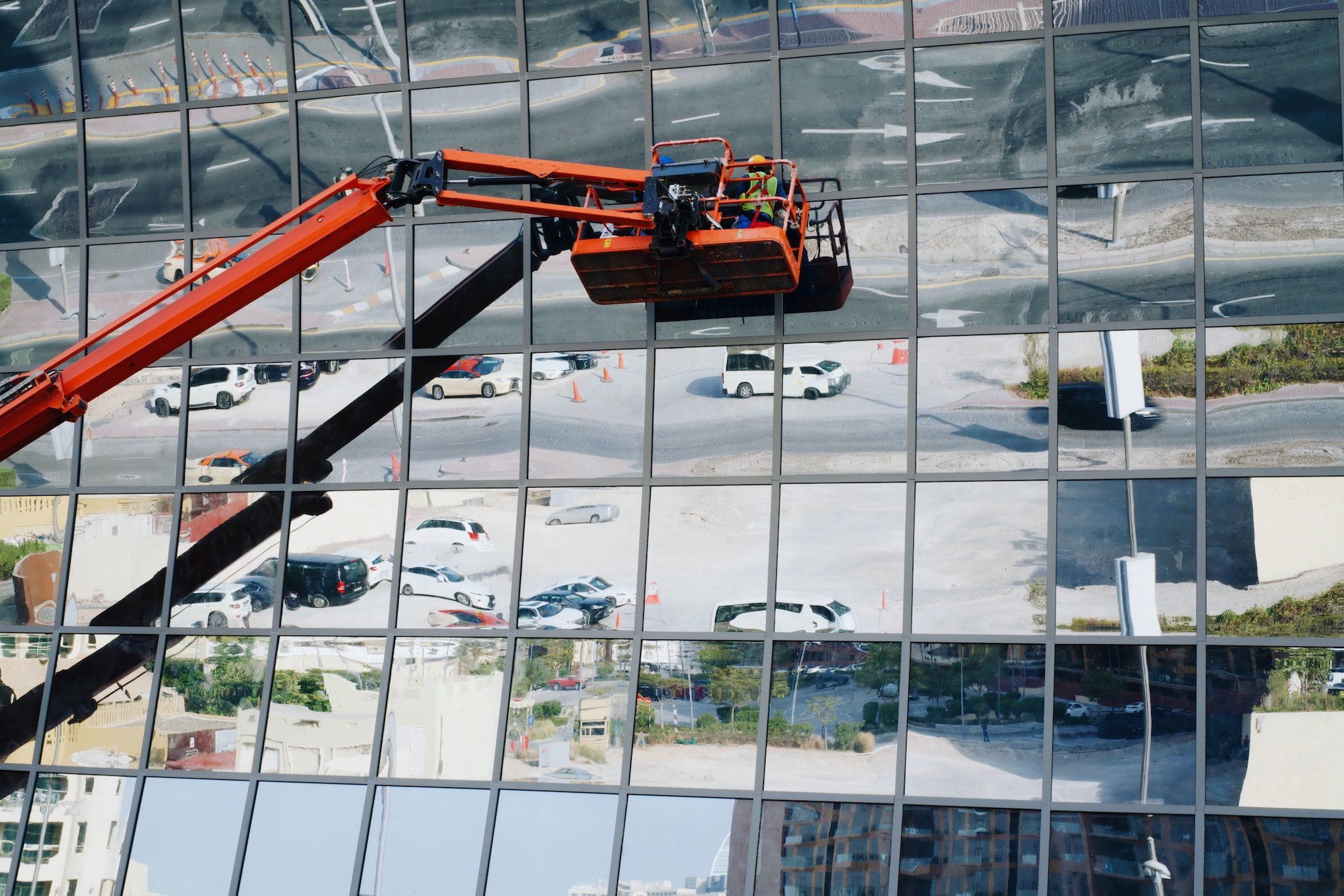 People in the crane cleaning exterior windows