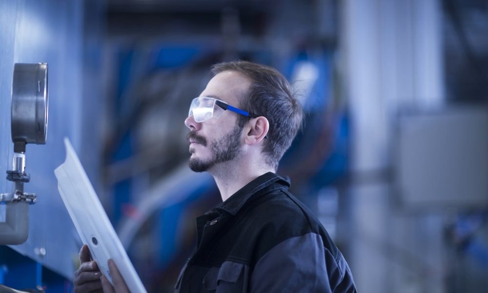 Engineer checking pressure gauge