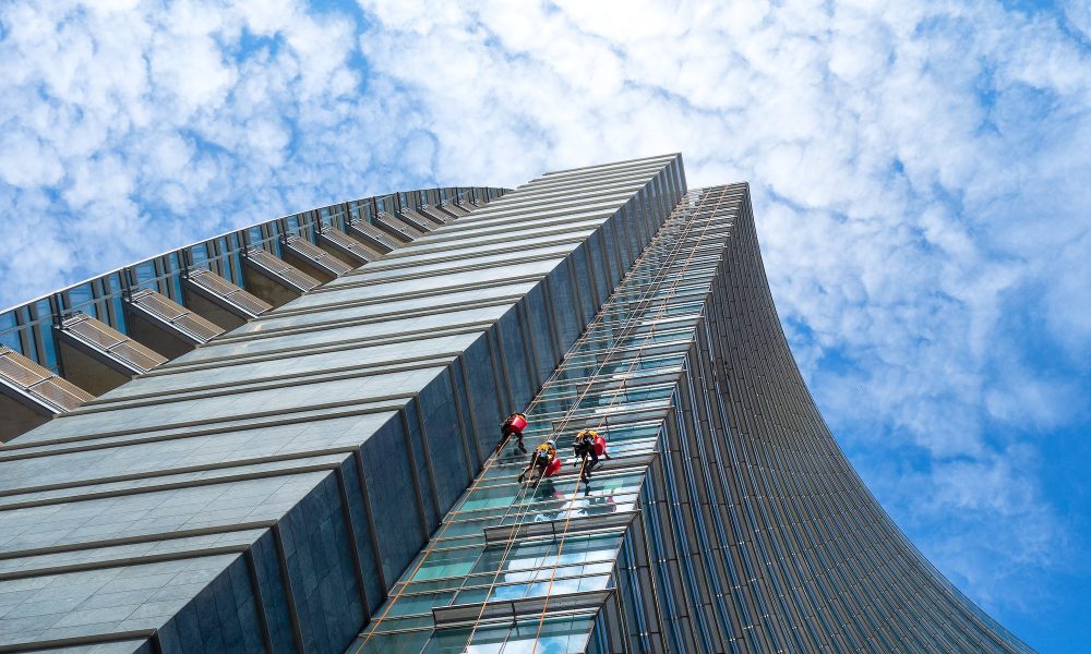 Group of Alpinists in service for windows cleaning of skyscraper