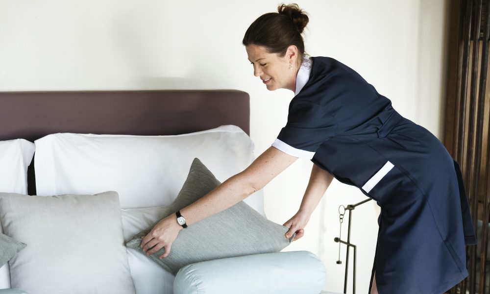 Housekeeper cleaning a hotel room