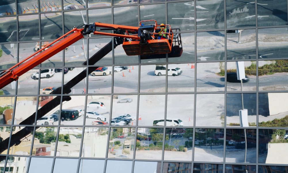 People in the crane cleaning exterior windows