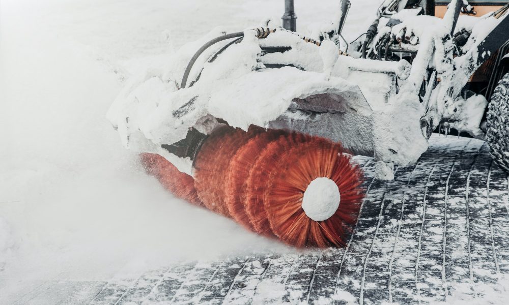 Tractor cleans road from snow after blizzard or heavy snowstrom. Cleaning or plowing snow